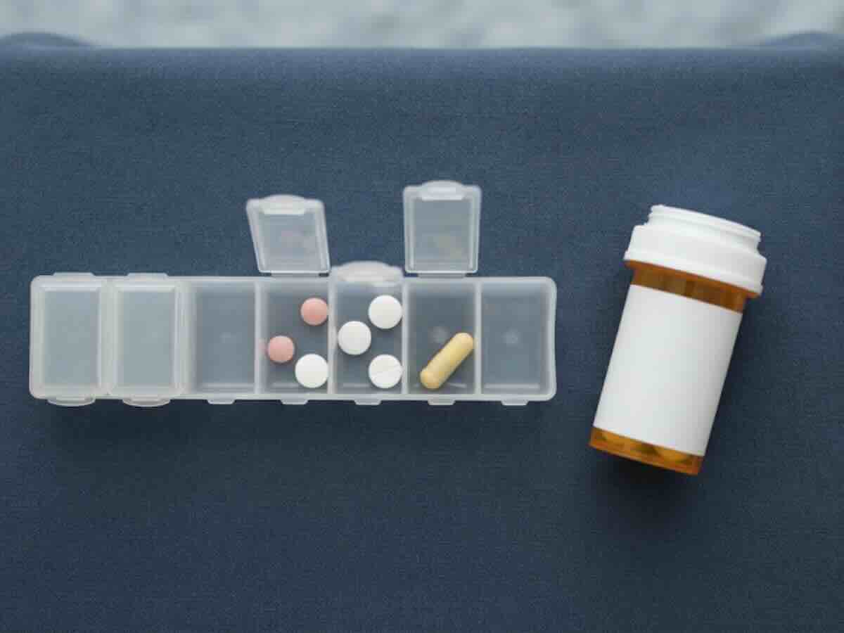 Prescription medication organized in a weekly pill organizer for type 2 diabetes management